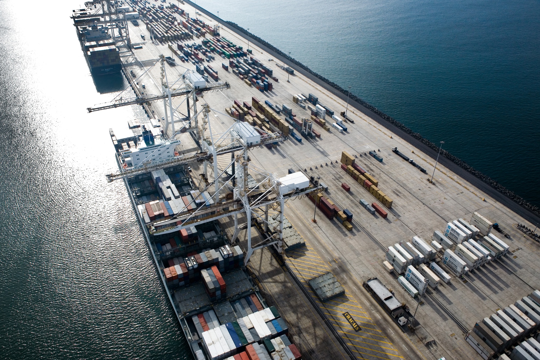 Aerial view of the Cape Town container terminal in South Africa with stacked shipping containers and ship-to-shore cranes