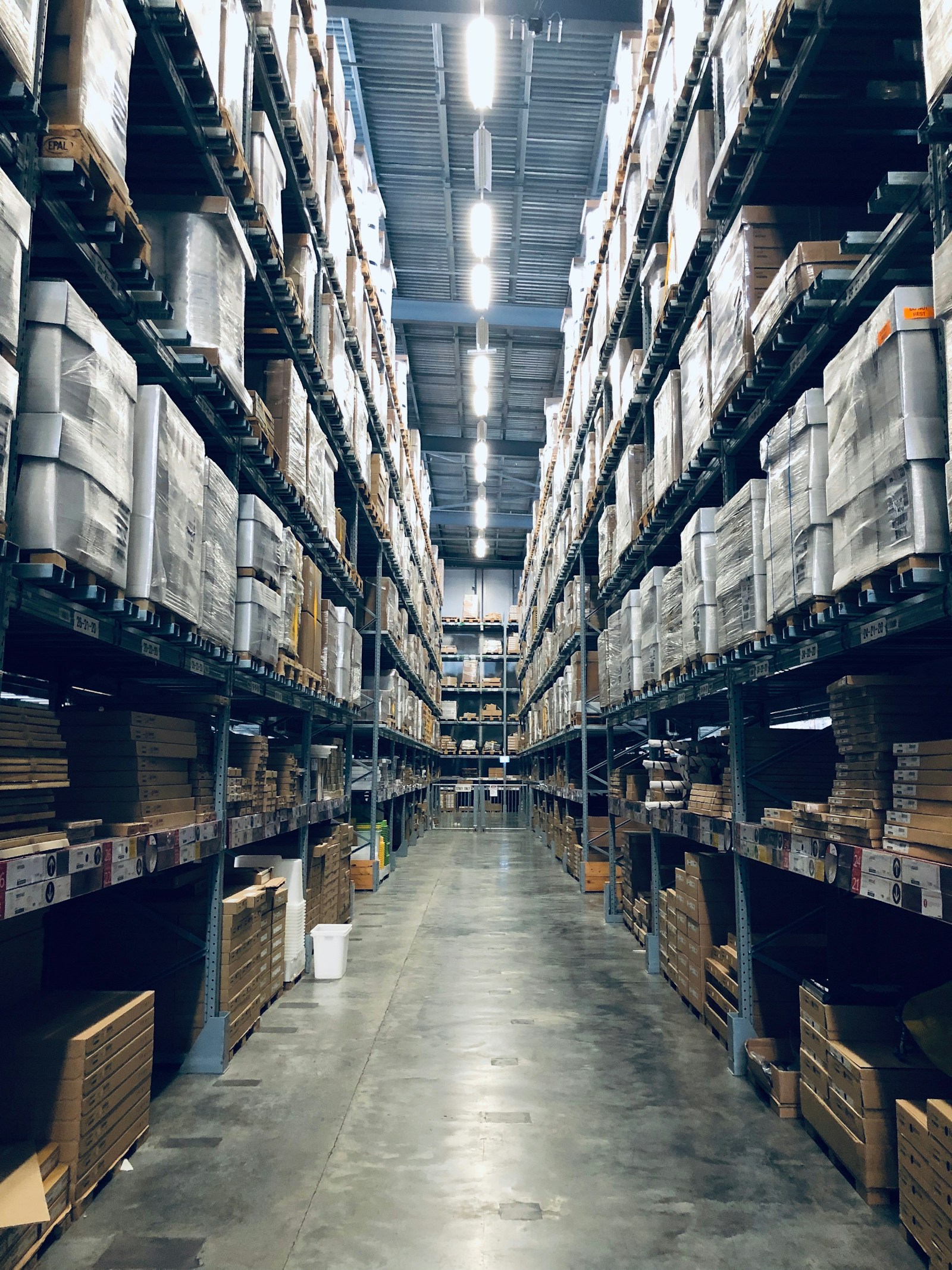 Warehouse aisle with stocked shelves for UK and Ireland import sourcing from China